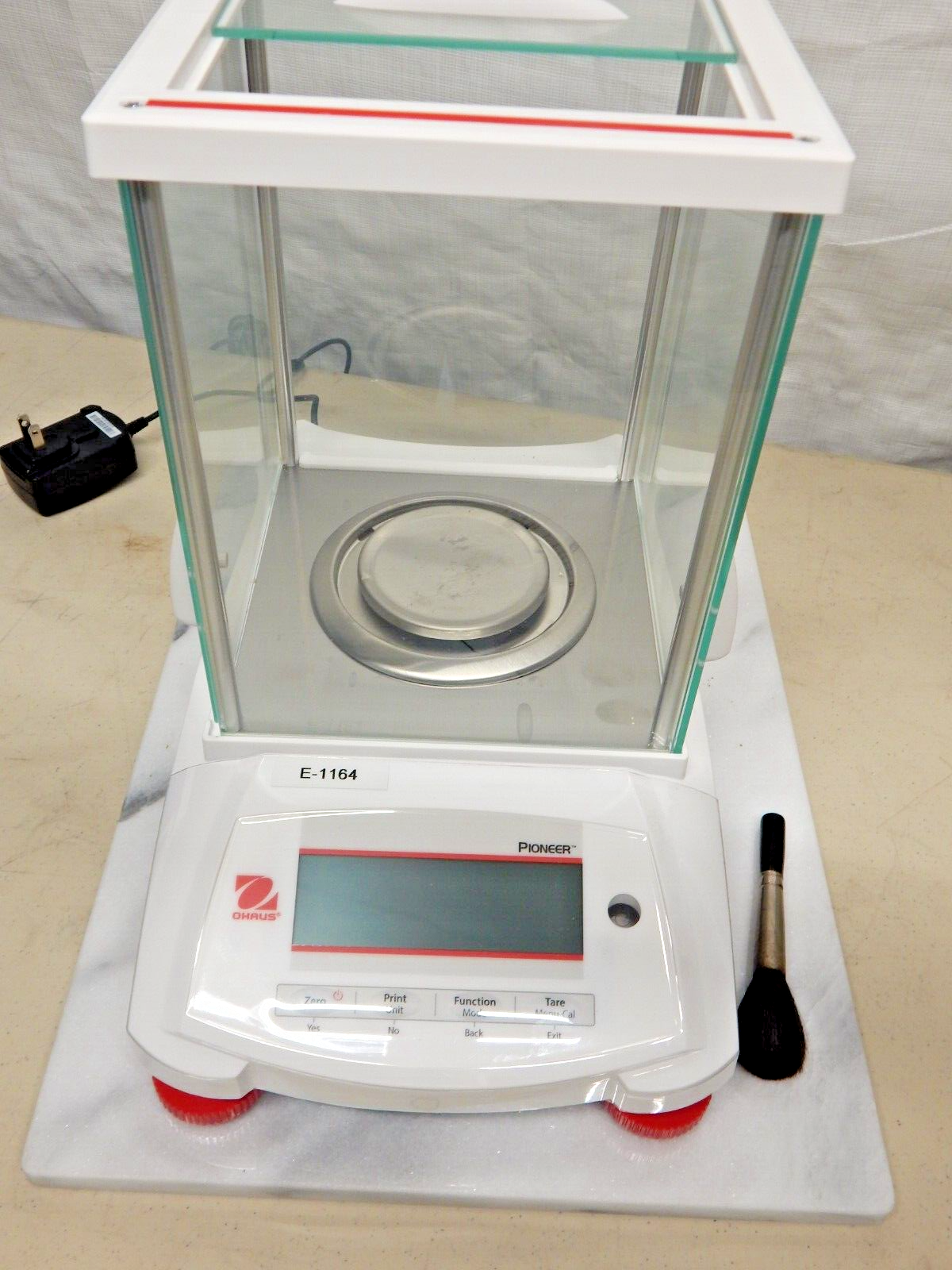 An analytical balance on a marble table.