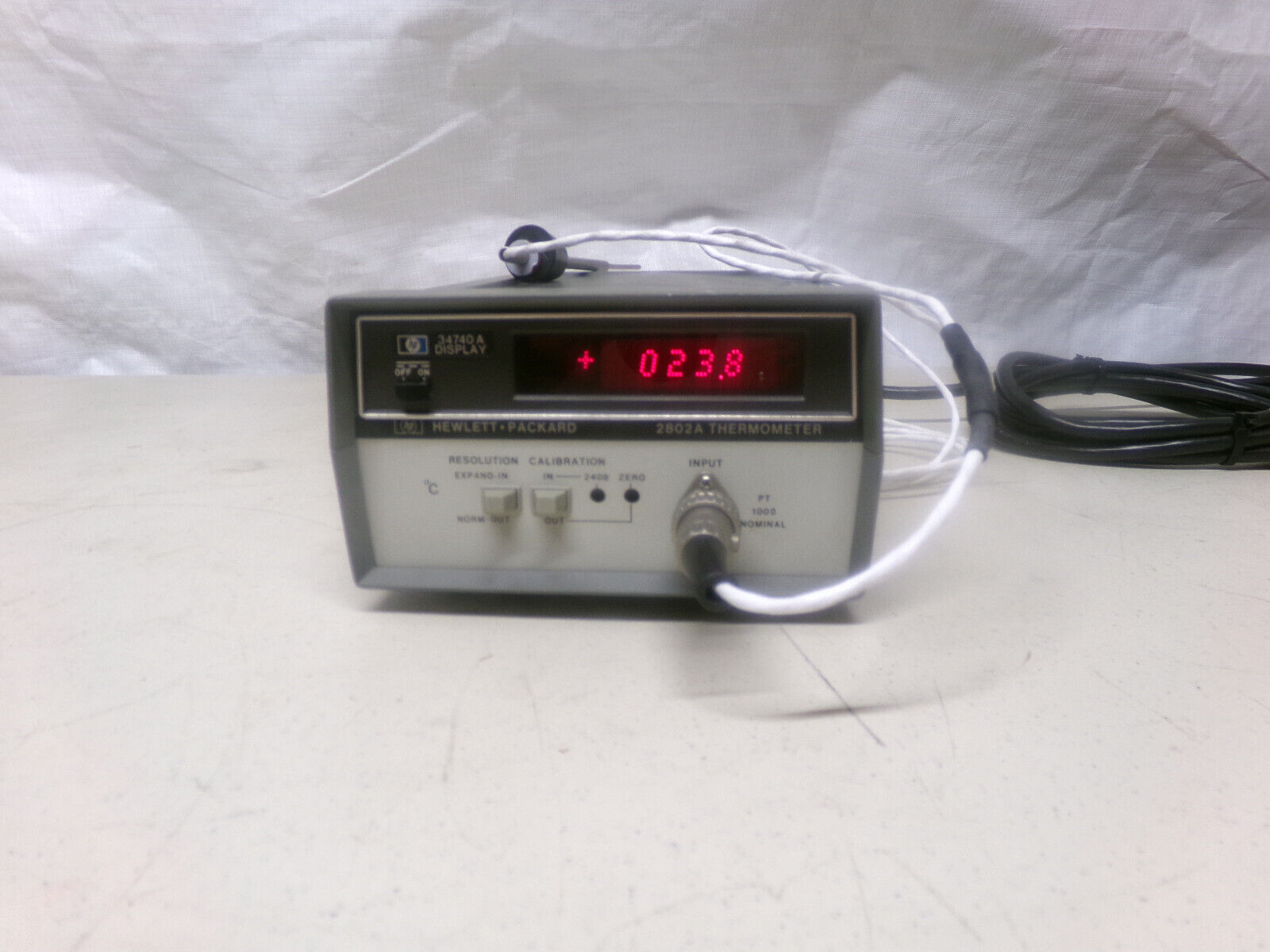 A gray box with a red LED display that reads "023.8".