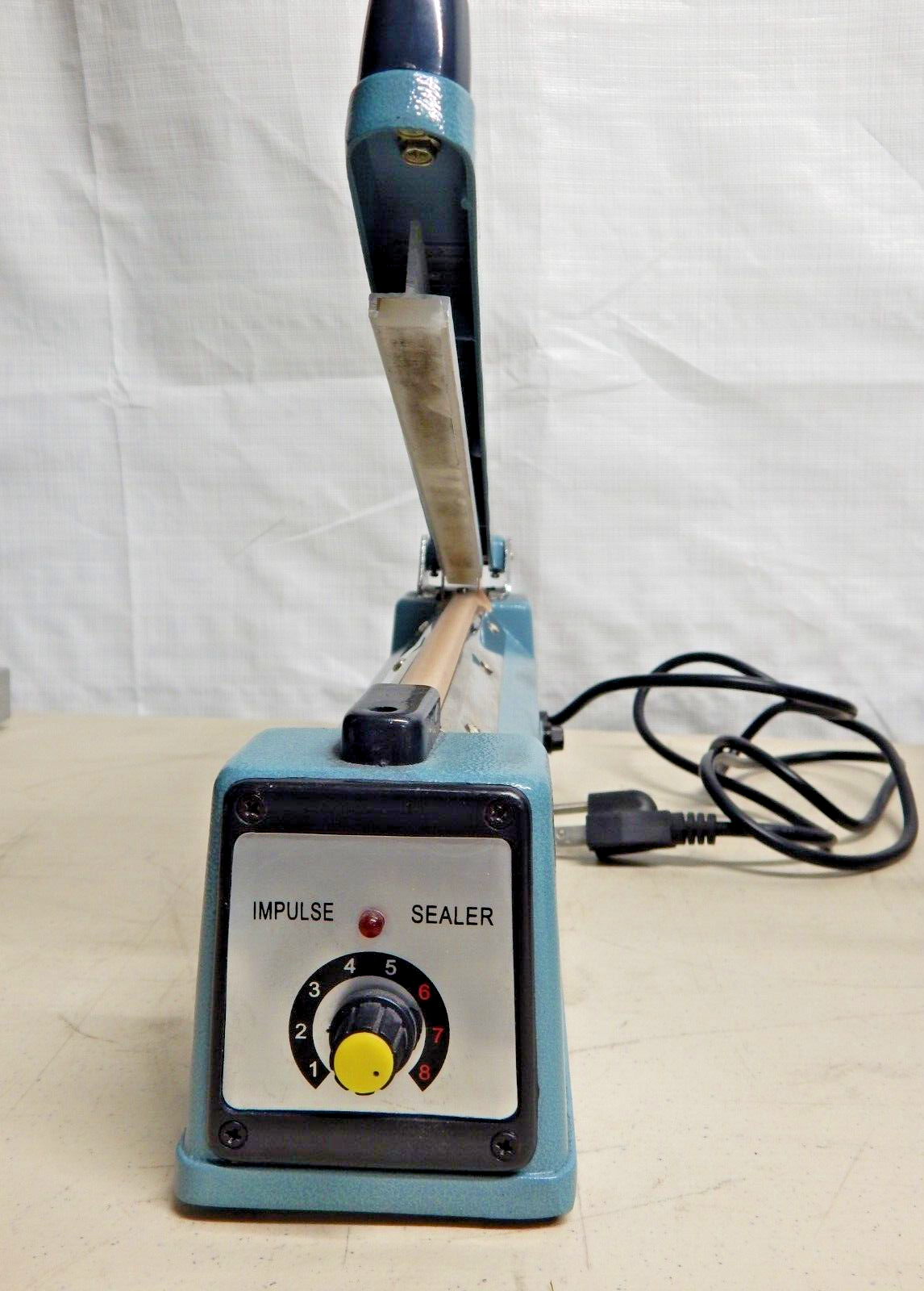 A blue impulse heat sealer machine.