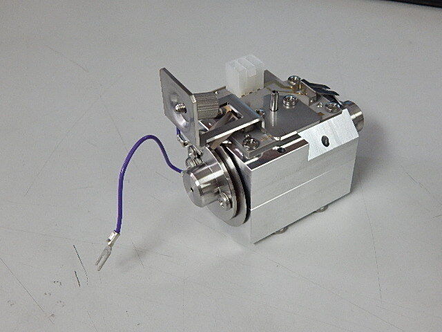 Stepper motor with a worm gear reducer.