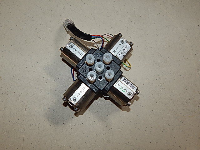 Black 4-way pneumatic valve with electrical connections.