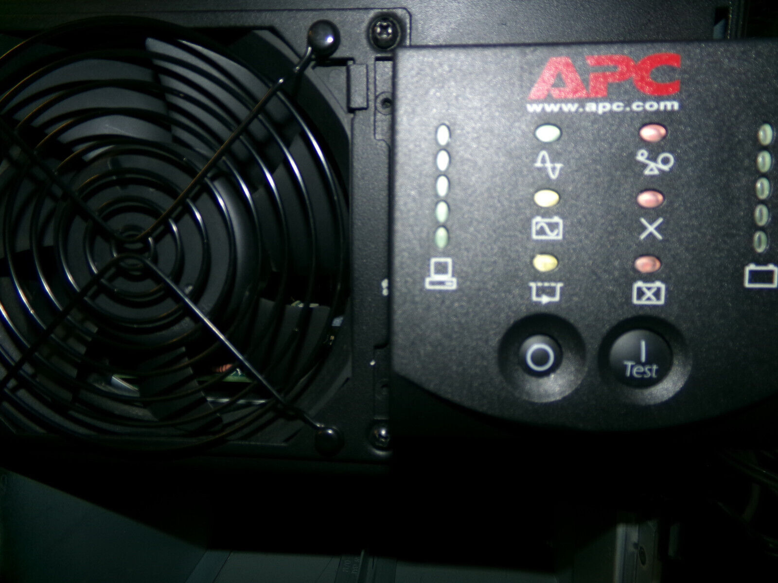 Black APC UPS with green and red indicator lights.