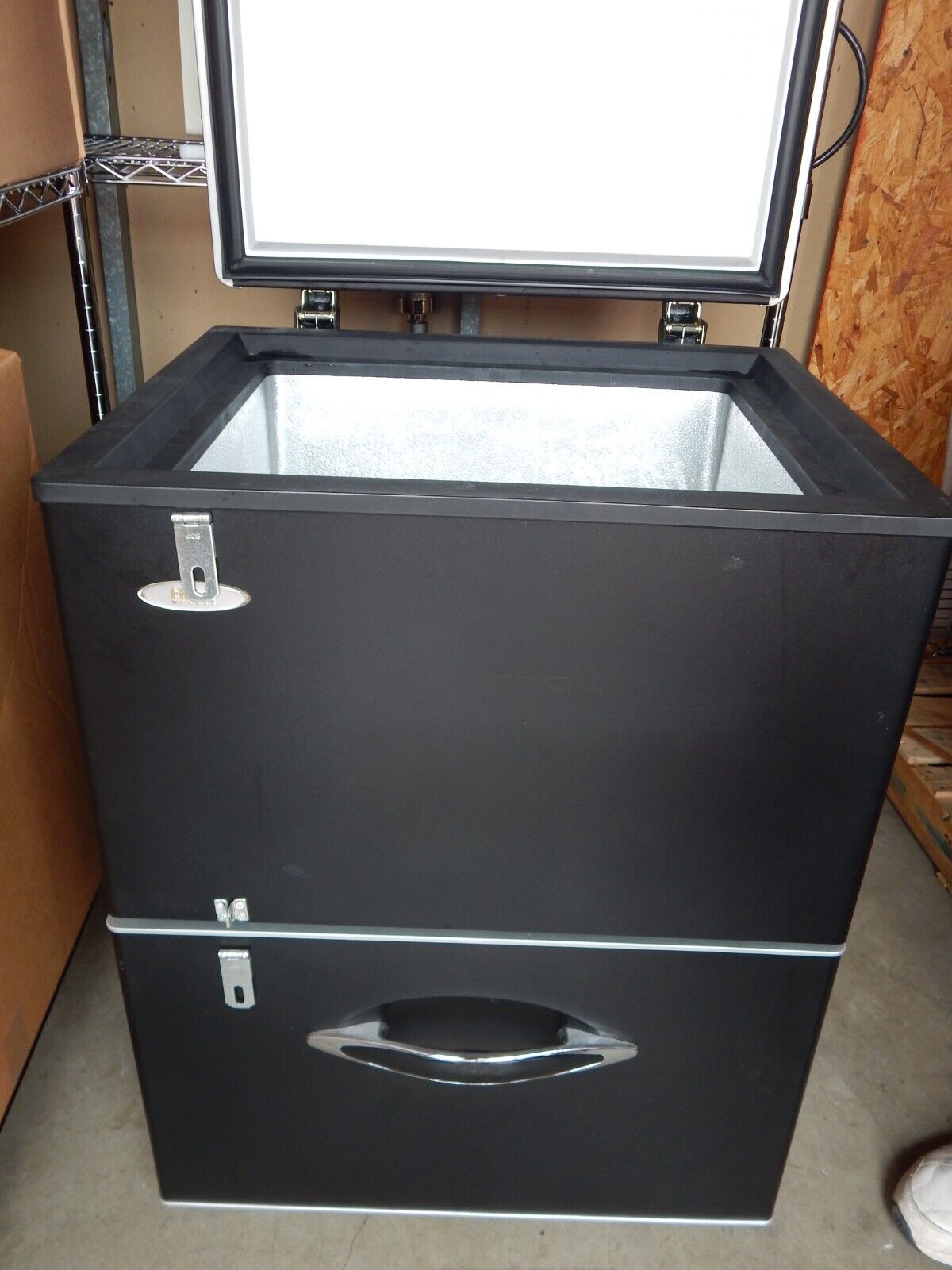Black chest freezer with two drawers.