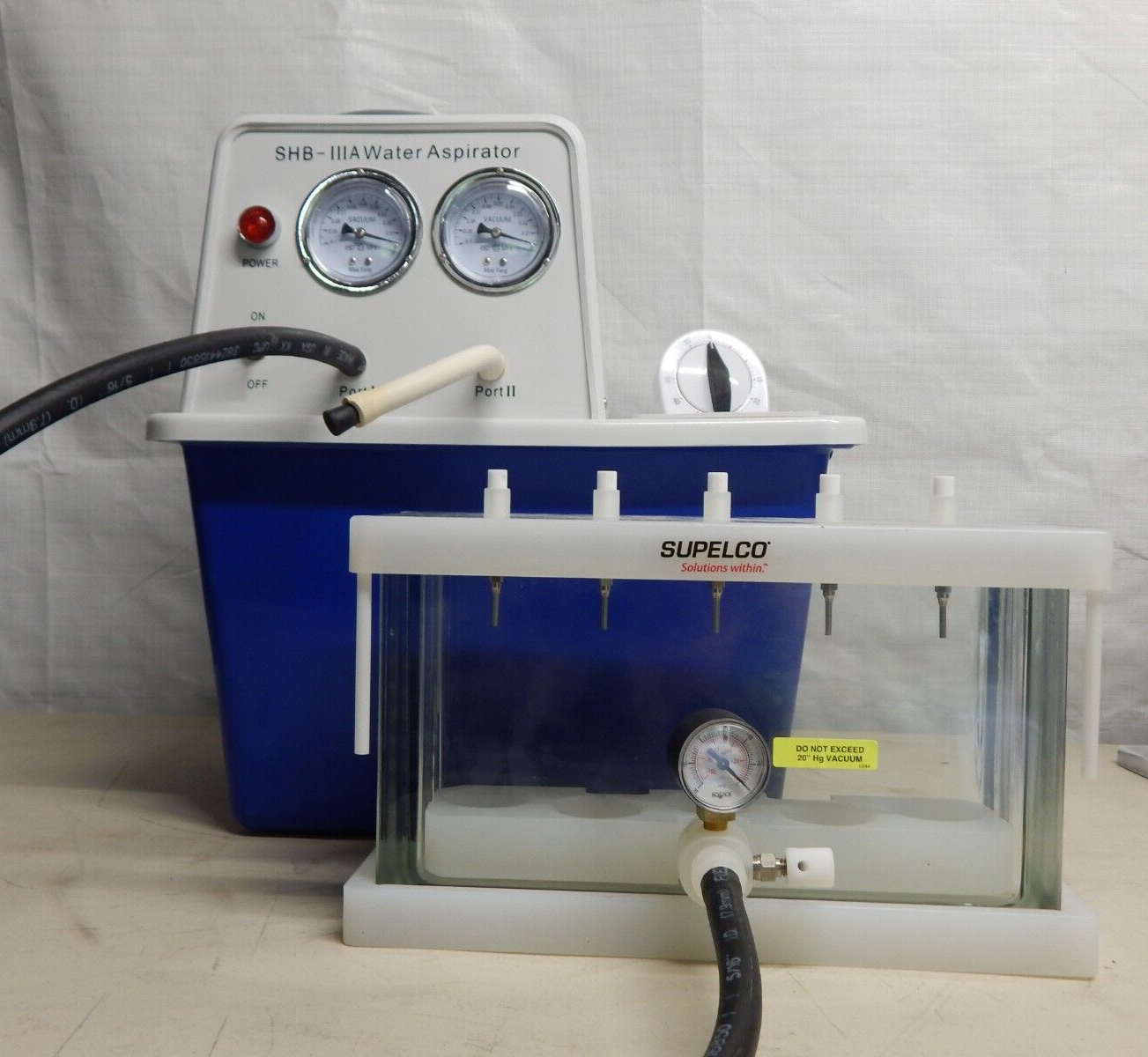 Manifold with four glass tubes in water.